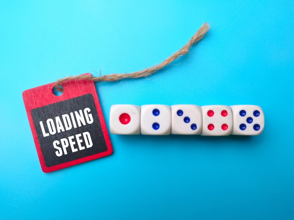 Dice and wooden board with the word LOADING SPEED.